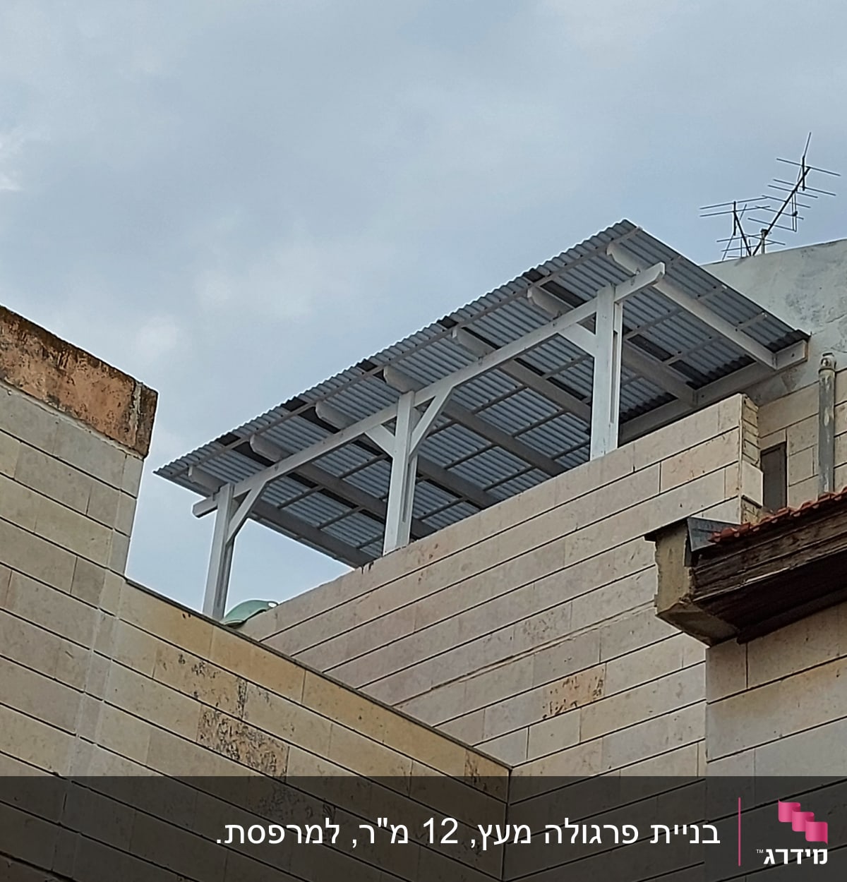 גג מתכת עם אנטנה על מבנה אבן